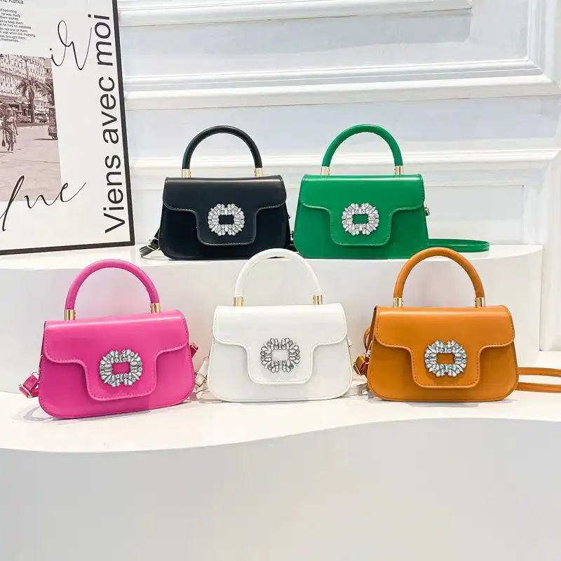 Elegant pink mini handbag with sparkling buckle and crossbody strap Elegant pink mini handbag with sparkling buckle and crossbody strap