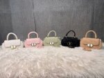 Elegant mini top handle handbag for women with gold lock closure and structured design