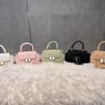 Elegant mini top handle handbag for women with gold lock closure and structured design